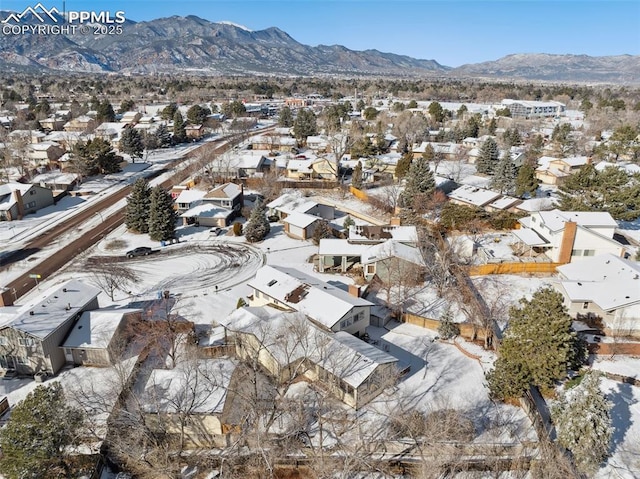 snowy aerial view featuring a mountain view