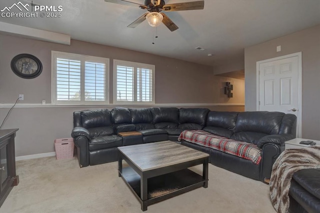 living room with carpet, baseboards, and a ceiling fan