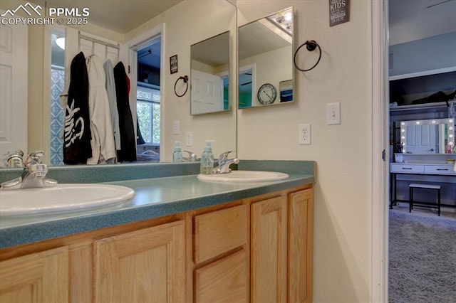 bathroom with a sink and double vanity