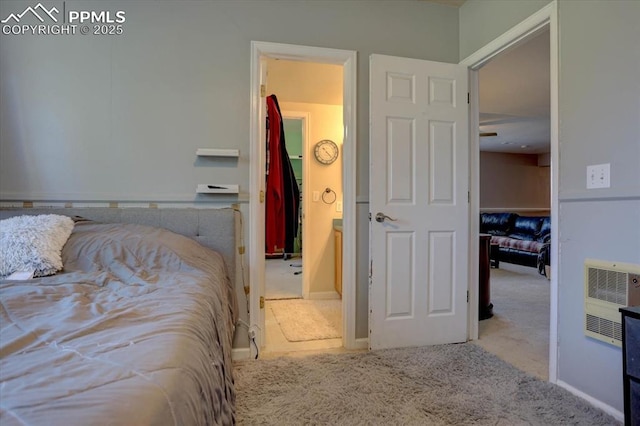 bedroom featuring baseboards, carpet flooring, and heating unit