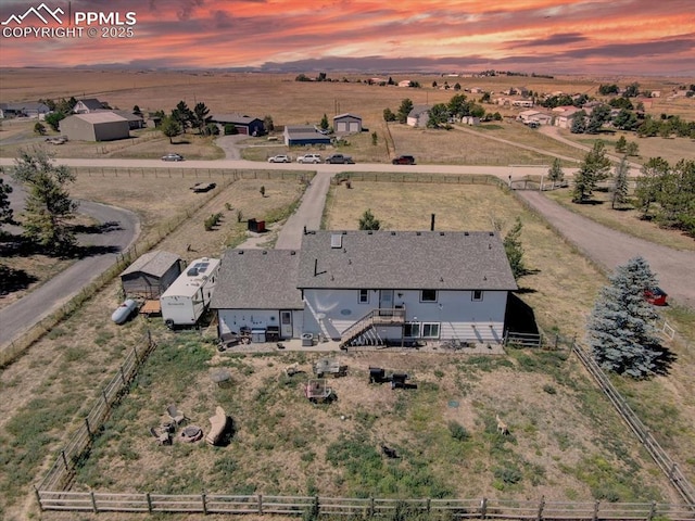 aerial view at dusk featuring a rural view