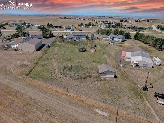 aerial view at dusk featuring a rural view