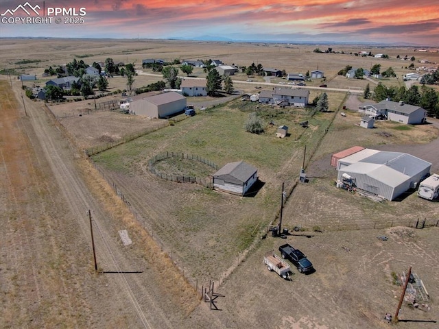 aerial view at dusk featuring a rural view