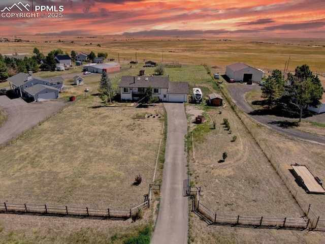 aerial view at dusk featuring a rural view