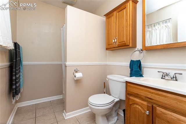 bathroom with tile patterned floors, vanity, and toilet