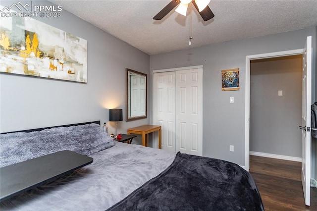 bedroom with a textured ceiling, a closet, ceiling fan, and dark hardwood / wood-style floors