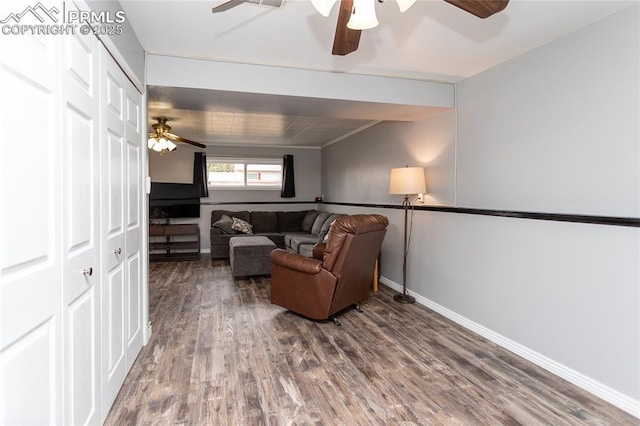 sitting room with hardwood / wood-style floors and ceiling fan