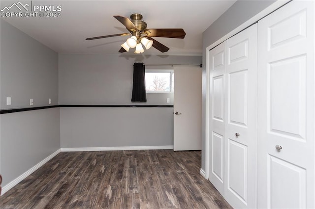 interior space with ceiling fan and dark hardwood / wood-style flooring