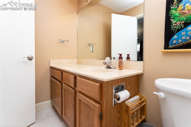 bathroom featuring tile patterned flooring, vanity, and toilet