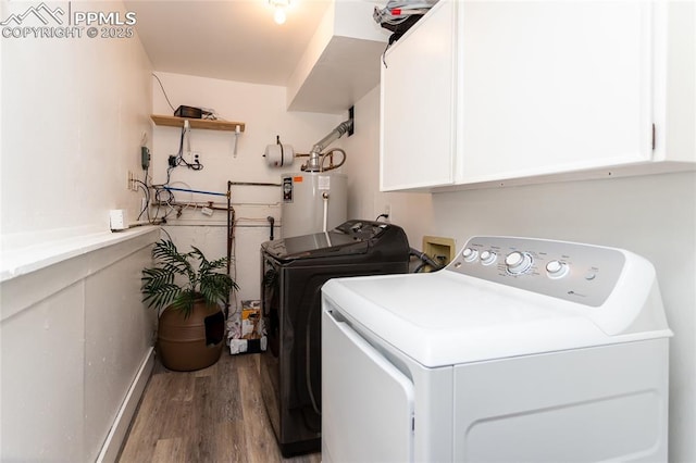 laundry area featuring washer and clothes dryer, cabinets, gas water heater, and light hardwood / wood-style floors