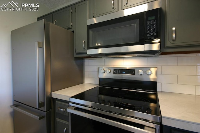 kitchen featuring stainless steel appliances and tasteful backsplash