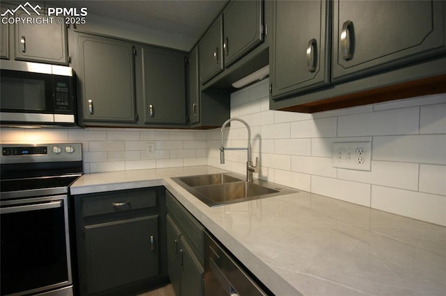 kitchen with backsplash, sink, and appliances with stainless steel finishes