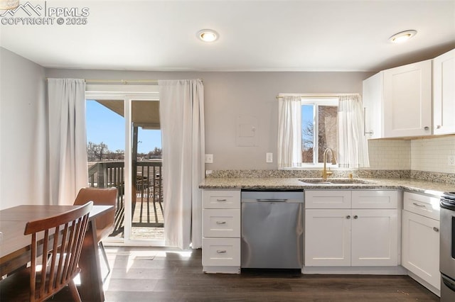 kitchen with dark hardwood / wood-style flooring, dishwasher, light stone countertops, white cabinets, and sink