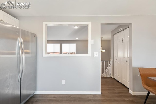 kitchen featuring dark hardwood / wood-style floors, white cabinets, and stainless steel fridge