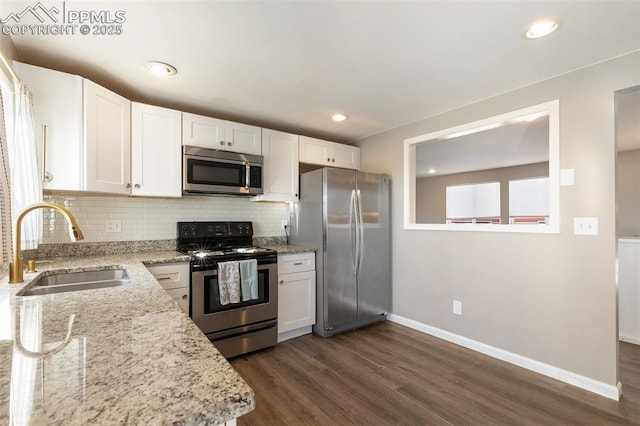 kitchen featuring appliances with stainless steel finishes, sink, and white cabinetry