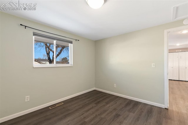 empty room featuring dark wood-type flooring