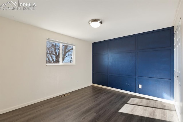 unfurnished room with dark hardwood / wood-style floors