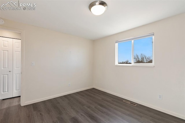 empty room with dark hardwood / wood-style floors