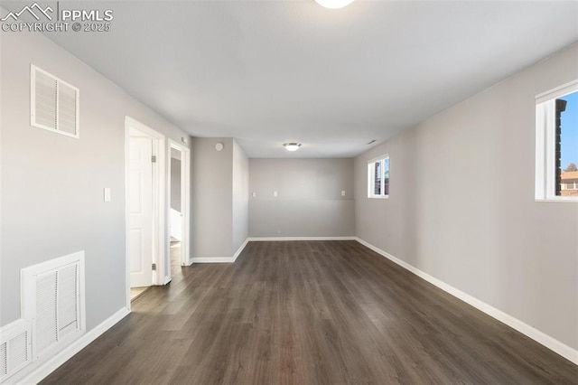 spare room with dark hardwood / wood-style flooring