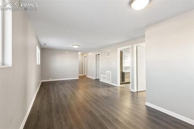 unfurnished room featuring dark hardwood / wood-style flooring