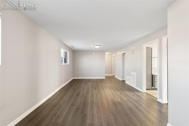 empty room featuring dark wood-type flooring