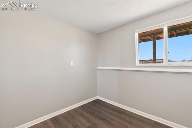 unfurnished room with dark hardwood / wood-style floors