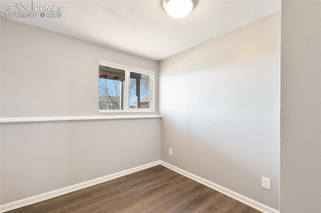 spare room with dark wood-type flooring