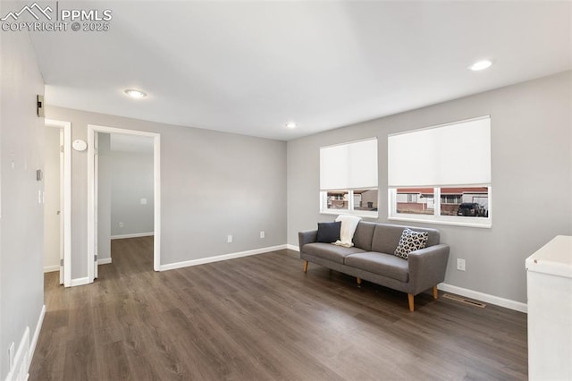 sitting room with dark hardwood / wood-style flooring