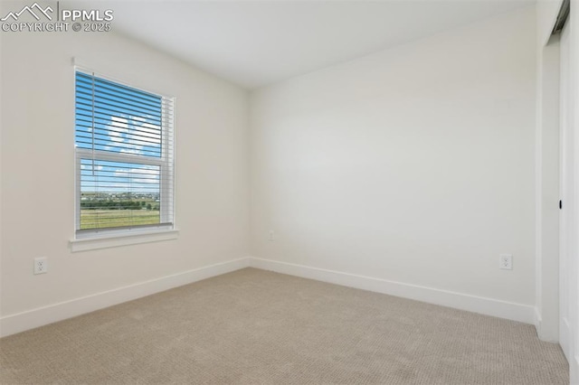 unfurnished room featuring light colored carpet