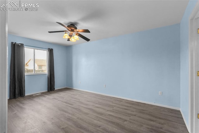 unfurnished room featuring wood finished floors, a ceiling fan, and baseboards