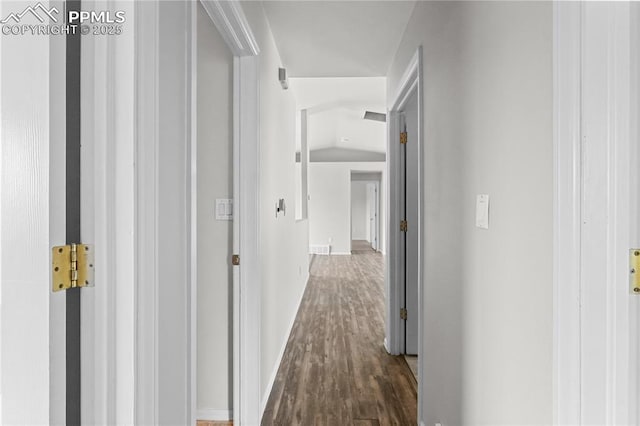 corridor with visible vents, baseboards, and wood finished floors