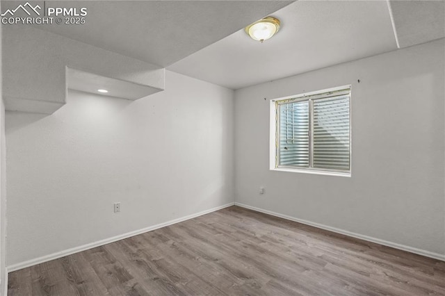 interior space featuring light wood-type flooring and baseboards