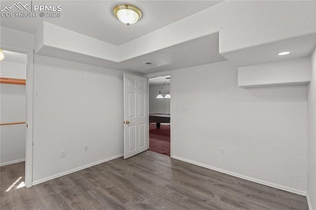 interior space with wood finished floors, visible vents, and baseboards