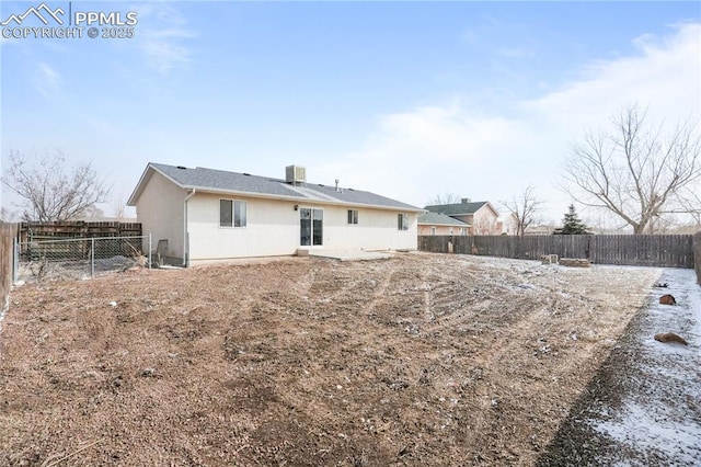 back of house featuring a fenced backyard and stucco siding