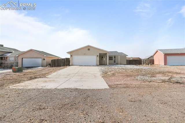 ranch-style house with fence and stucco siding