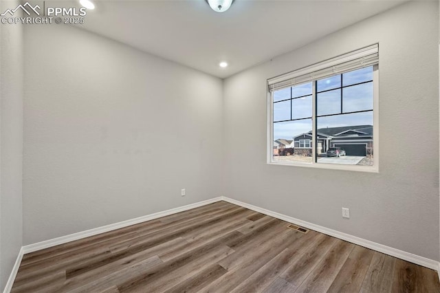 unfurnished room featuring hardwood / wood-style floors