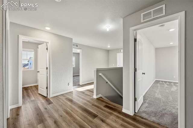 hall with hardwood / wood-style floors