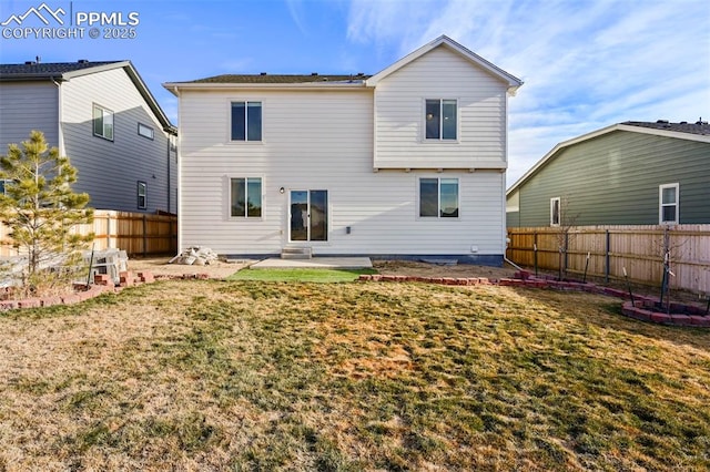 rear view of property with a yard and a patio area