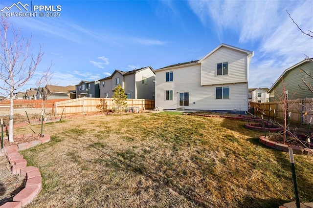 rear view of house with a lawn