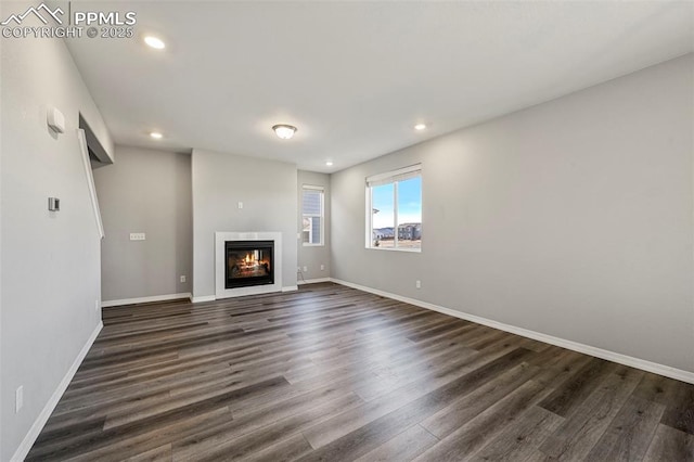 unfurnished living room featuring dark hardwood / wood-style floors