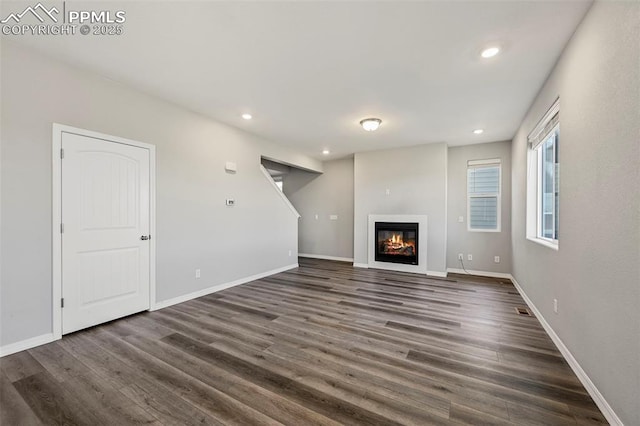 unfurnished living room featuring dark hardwood / wood-style floors