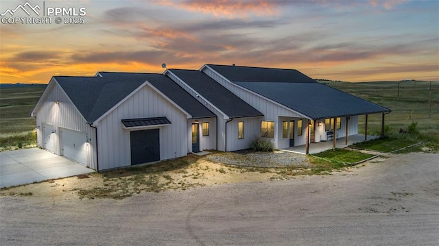 modern inspired farmhouse with a porch and a garage