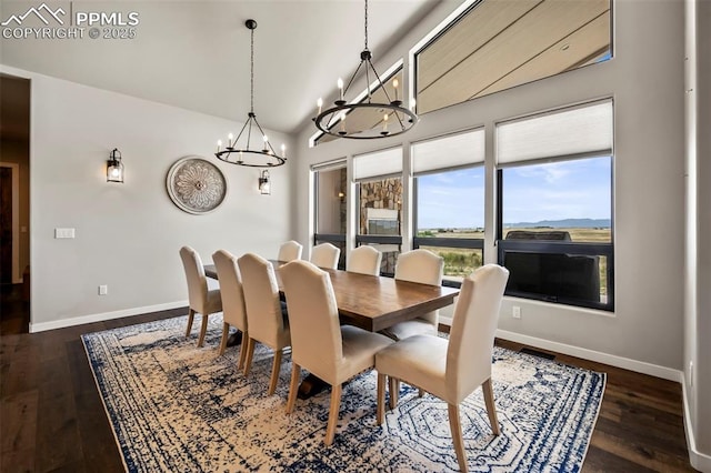 dining room with lofted ceiling, dark hardwood / wood-style floors, and a notable chandelier