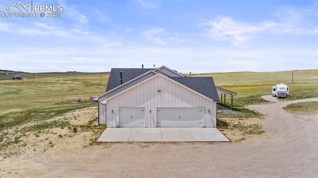 garage featuring a rural view