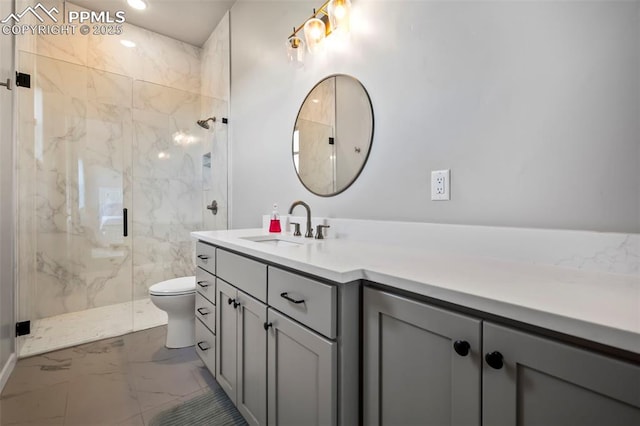 bathroom with vanity, toilet, and a shower with door