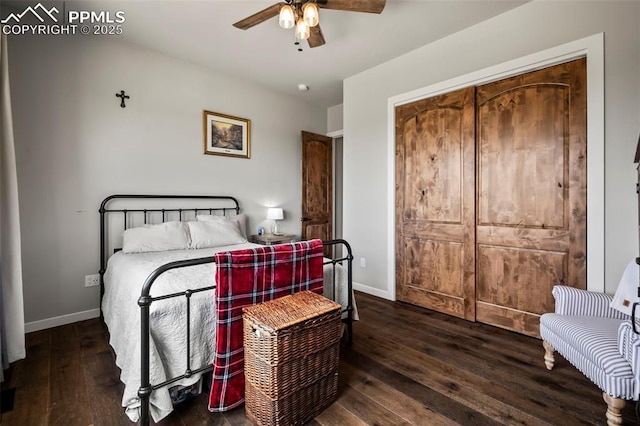 bedroom with dark hardwood / wood-style flooring and ceiling fan