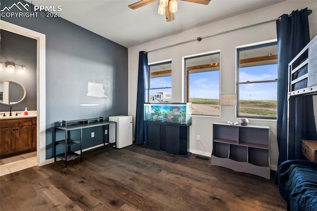 living room with ceiling fan, sink, and dark hardwood / wood-style floors