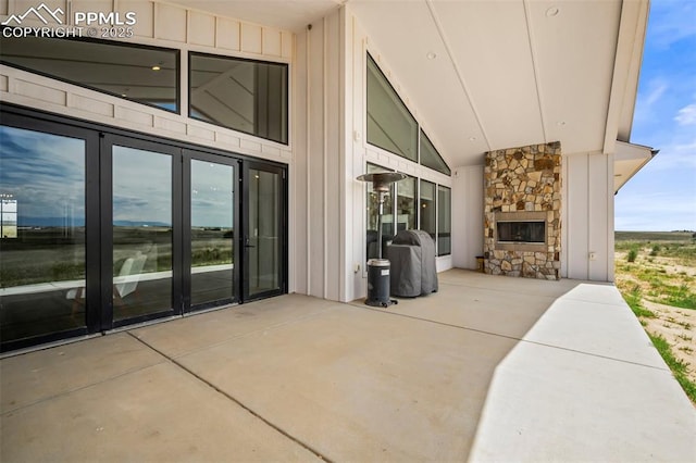 view of patio / terrace featuring an outdoor stone fireplace