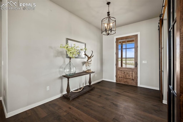 foyer entrance featuring a chandelier and dark hardwood / wood-style floors