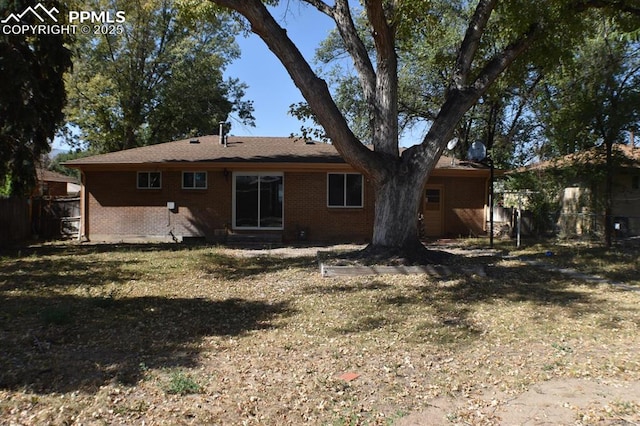 back of house with a lawn